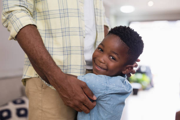 istock Mid section of happy boy embracing father 800476424