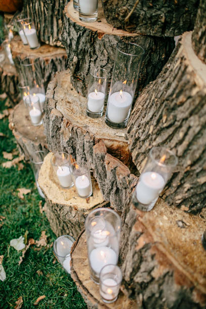 istock Wedding decorations in rustic style. Outing ceremony. Wedding in nature. Candles in decorated goblets 800485538