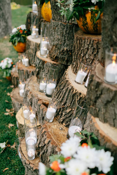 istock Wedding decorations in rustic style. Outing ceremony. Wedding in nature. Candles in decorated goblets 800485792
