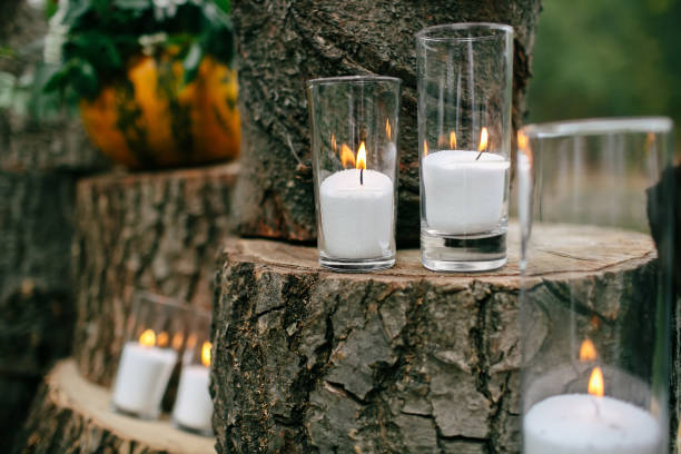 istock Candles in decorated goblets. Wedding decorations in rustic style. Outing ceremony. Wedding in nature. 800485838