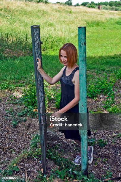 Girl On The Iron Gate Stock Photo - Download Image Now - Anticipation, Appliance, Arts Culture and Entertainment