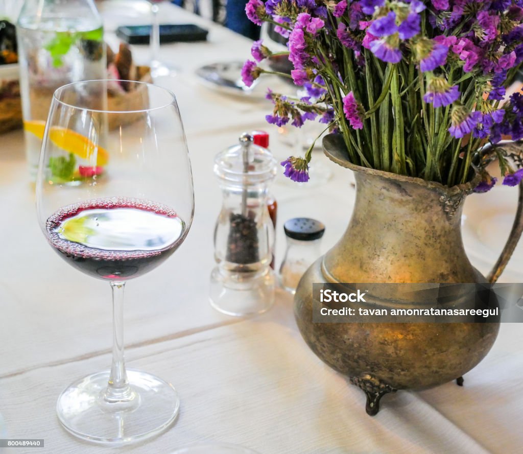 dinning table with glass of wine flower on dinning table with glass of wine Arts Culture and Entertainment Stock Photo