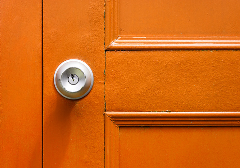 Closeup of knob with yellow door in vintage.