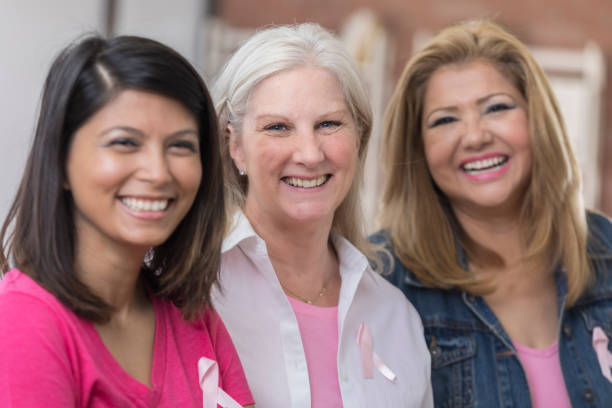 istock Three cancer survivors smile and stand beside each other 800493504