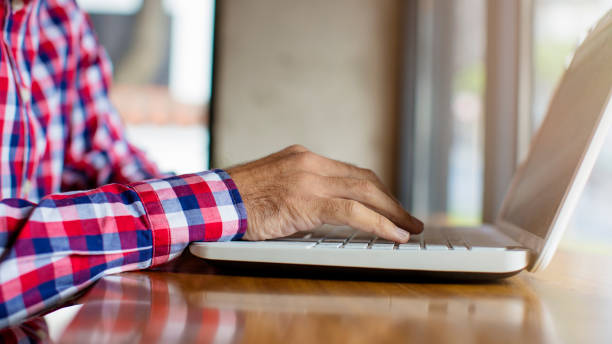 istock Man typing on laptop keybord close up 800510388
