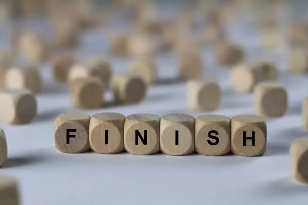 Photo of finish - cube with letters, sign with wooden cubes