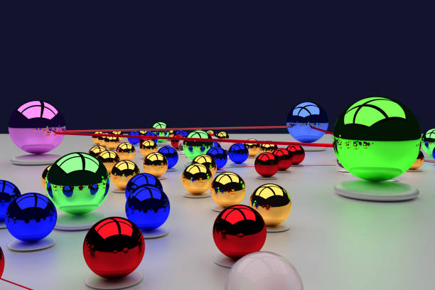 Group of egg-shaped sweets in a gold, red, green and blue wrapper on a black background. Isolated, studio shot, template with space for text.