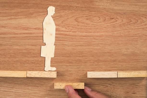 istock Personal development, personal and career growth, progress and potential concepts. Coach (human resources officer, manager, mentor) motivate employee to growth. Wooden blocks and businessman 800697140