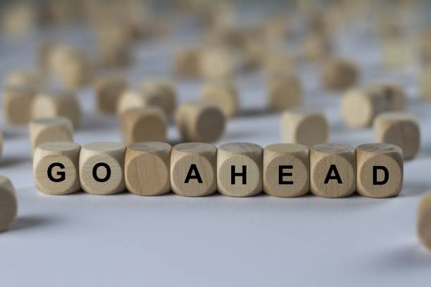 istock go ahead - cube with letters, sign with wooden cubes 800702748