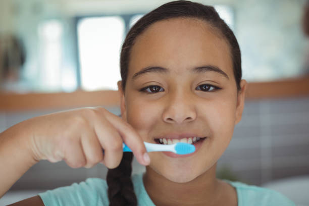 istock Girl brushing teeth in the bathroom 800717208