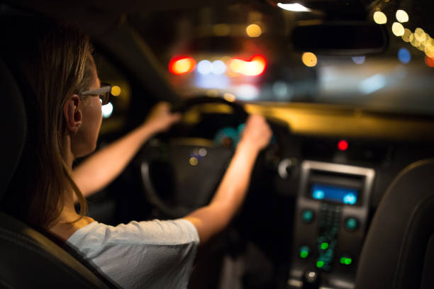 istock Female drive driving a car at night 800743340