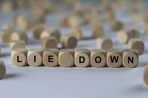 istock lie down - cube with letters, sign with wooden cubes 800835380