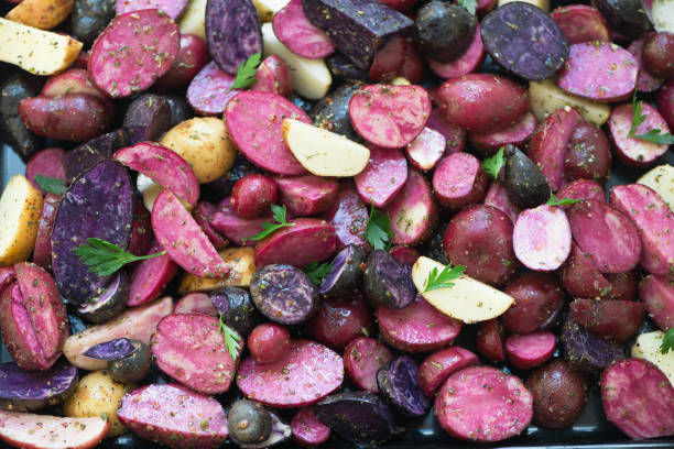 Close view of raw sliced purple and pink potatoes. stock photo