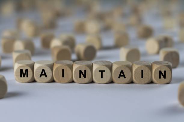 istock maintain - cube with letters, sign with wooden cubes 800845236