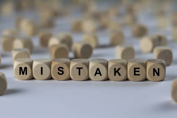 istock mistaken - cube with letters, sign with wooden cubes 800846598