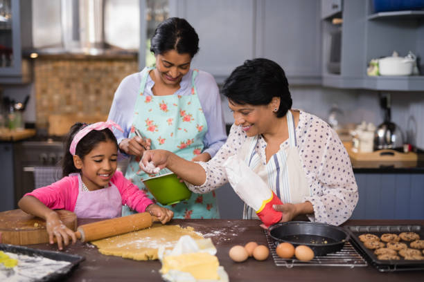 istock Multi-generation family preparing food together 800848812