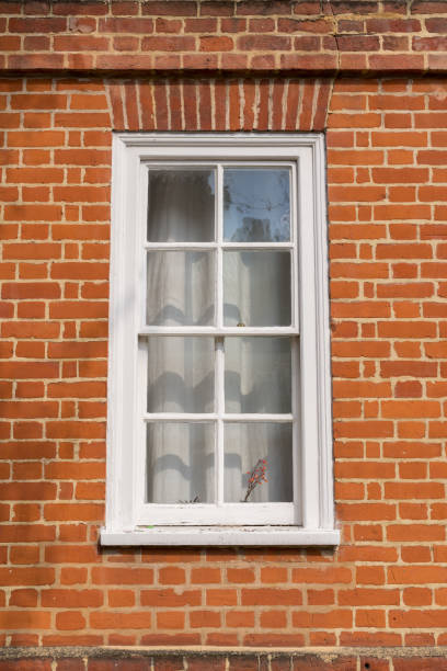 istock White vintage wooden window on a restored red brick wall 800855590