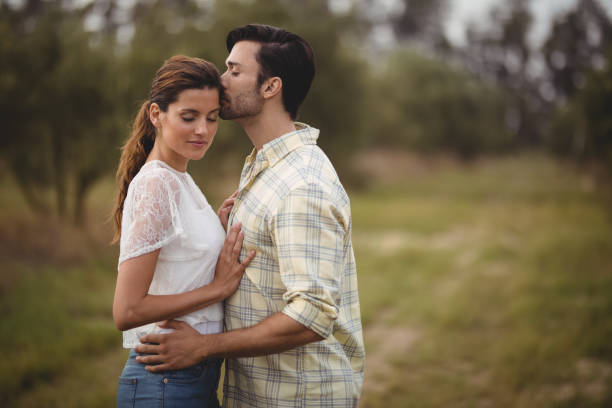 istock Young couple romancing on field at farm 800866574