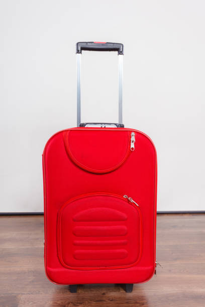 istock Red suitcase for traveling on floor at home 800871482