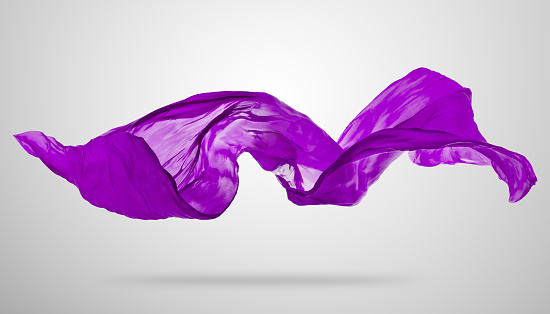 Smooth elegant purple transparent cloth separated on gray background. Texture of flying fabric.