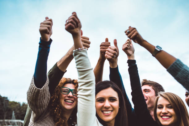 istock happiness friends thumbs up for victory 800881060