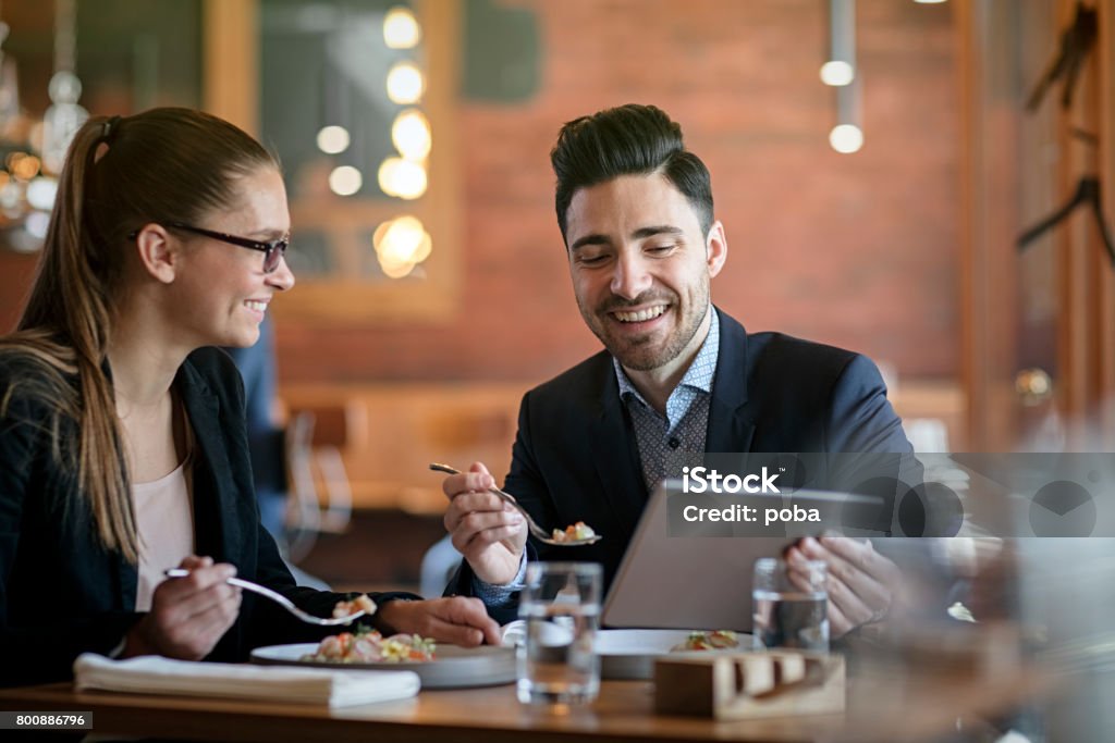 Businesspeople Having Meeting and Lunch In A Restaurant Business Lunch Stock Photo