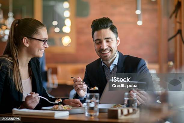Businesspeople Having Meeting And Lunch In A Restaurant Stock Photo - Download Image Now