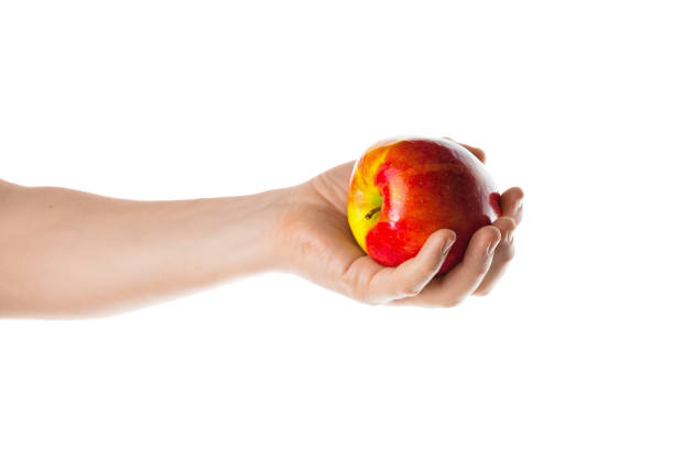 istock Apple. Male hand holding red apple. 800908438