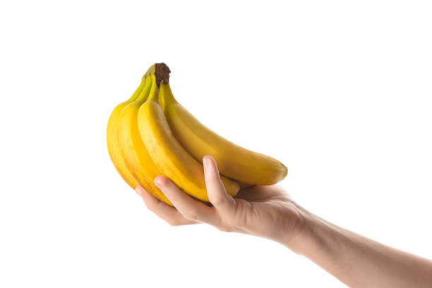 uomo che tiene un mucchio di banane in mano. isolato su bianco - men banana holding cut out foto e immagini stock