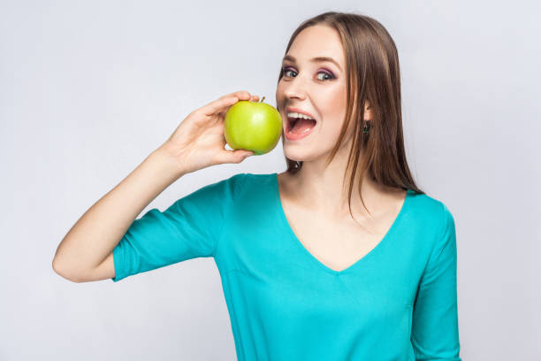 istock Young beautiful woman with apple. 800917030