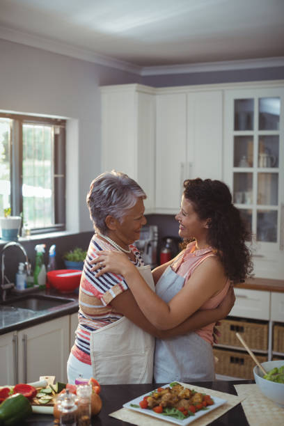 istock Mother hugging daughter in kitchen 800919884