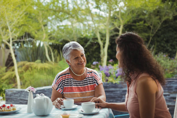 istock Mother and daughter having tea 800920094