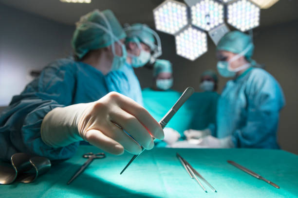 Surgeons in full surgical gear during operation stock photo