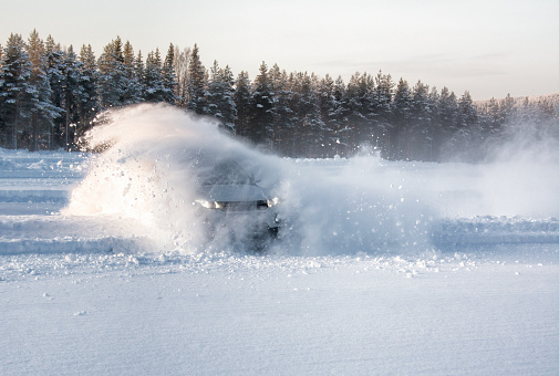 A vehicle sliding into deep snow causing an explosion effect
