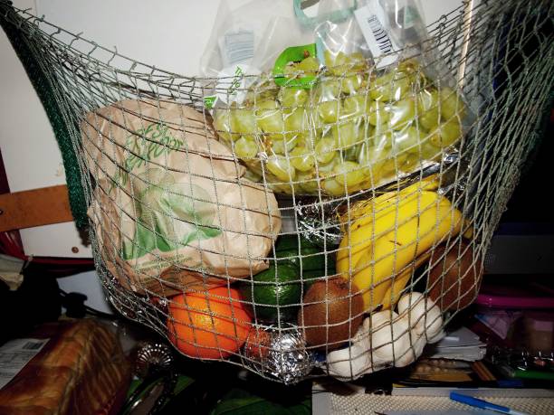 istock A mixed bag of colourful fruit hanging in a string basket. 800925492