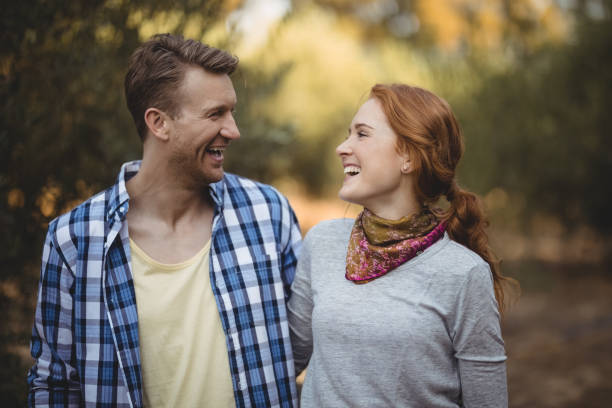 istock Cheerful couple looking at each other at olive farm 800950642