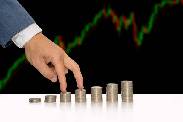 istock Businessman hand walking on stacking of coins into increasing columns. Financial concept. 800953252