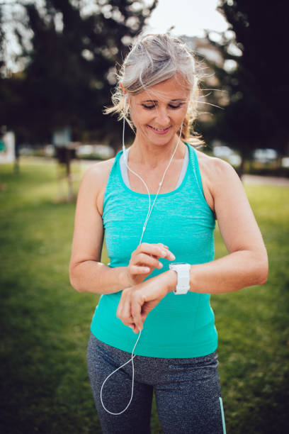 istock Fit mature woman runner checking her pulse on smartwatch 800977256