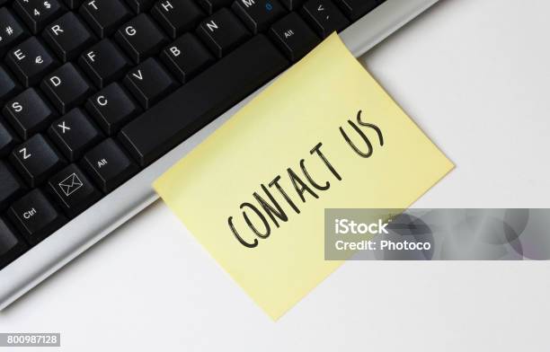 Keyboard And Contact Us Sticky Note Stock Photo - Download Image Now - Adhesive Note, Business, Business Finance and Industry