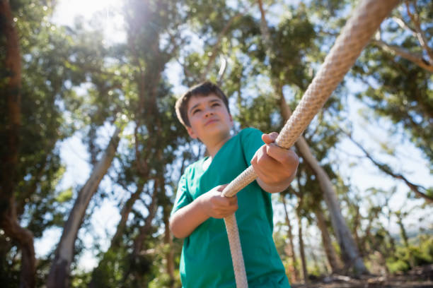 Boy practicing tug of war during obstacle course training Boy practicing tug of war during obstacle course training in the boot camp fitness boot camp stock pictures, royalty-free photos & images