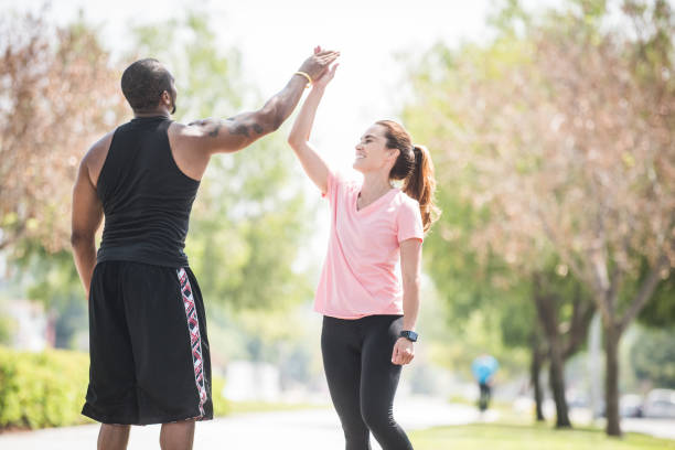 istock Personal Trainer High Fives a Client 800992260