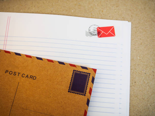 istock blur letter paper and postcard on brown paper background 800992812