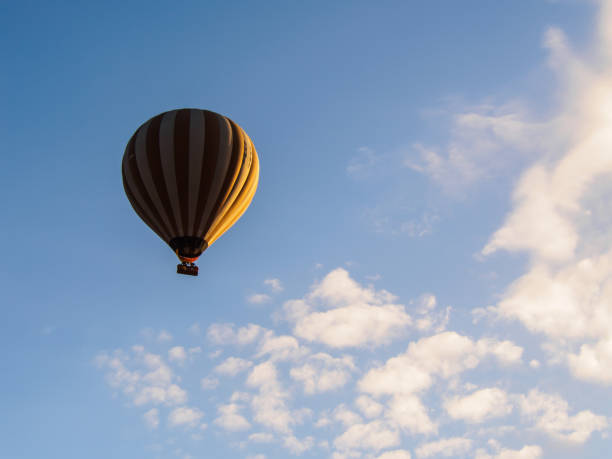 istock hot air balloon on blue sky with cloud background 800995194