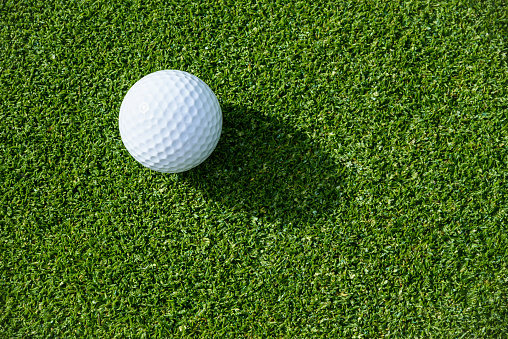 Top view of golf ball on a putting green