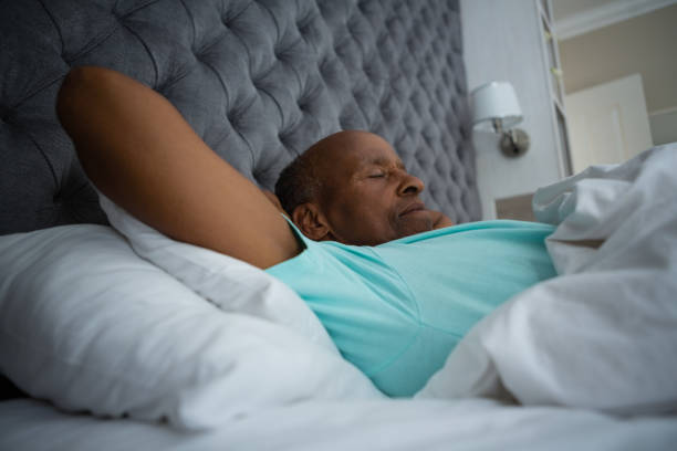 istock Side view of senior man sleeping on bed at home 801008552
