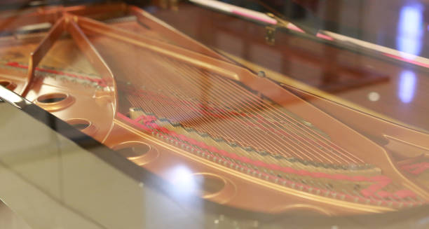 Grand Piano Strings with reflection of glass. Focus at center strings.