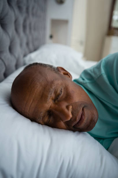 istock Close up of senior man sleeping on bed 801008562