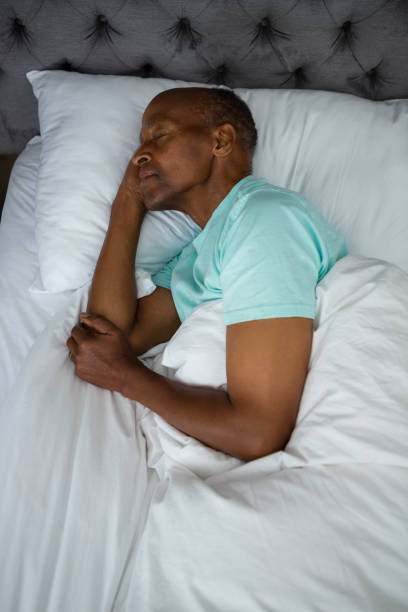 istock Overhead view of senior man sleeping on bed 801008570