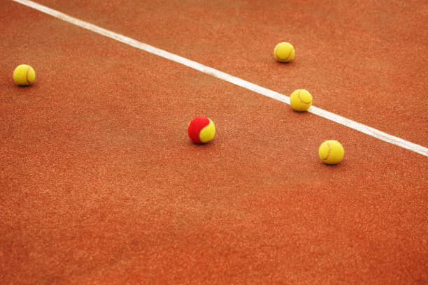 istock Ball on tennis court background 801021240