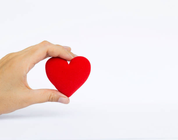 istock Girl hand holding red heart 801024782